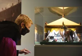 Woman looking at dollhouse tent