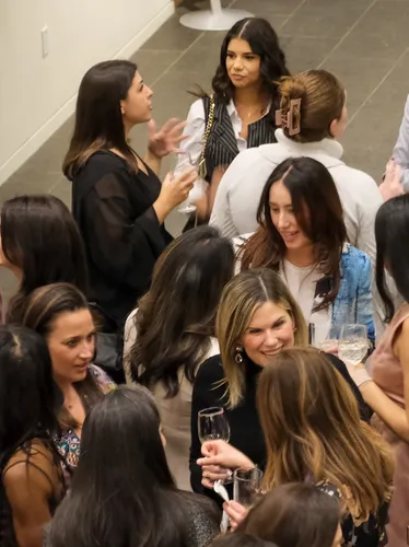 Photo of young adults enjoying a cocktail party at the Bruce Museum.