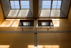 The exterior of the YCBA is made of steel and glass while the interior has a muted natural color palette composed of concrete, linen, travertine marbl